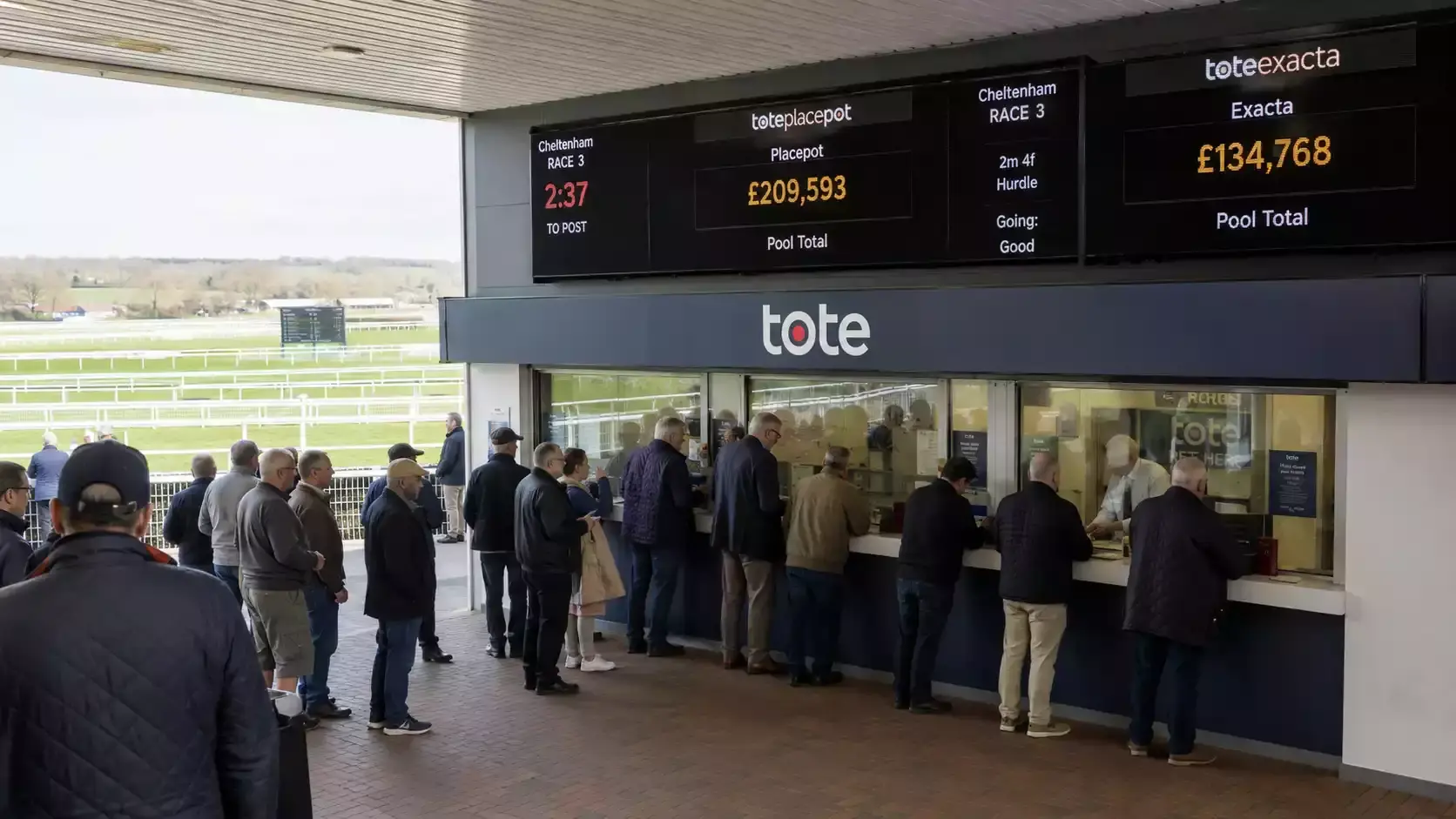 A Tote betting window at a UK racecourse showing pool totals updating before a race